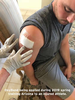 Baseball player being treated for spring training injury by OxyBand CEO Baseball player being treated for spring training injury by OxyBand CEO